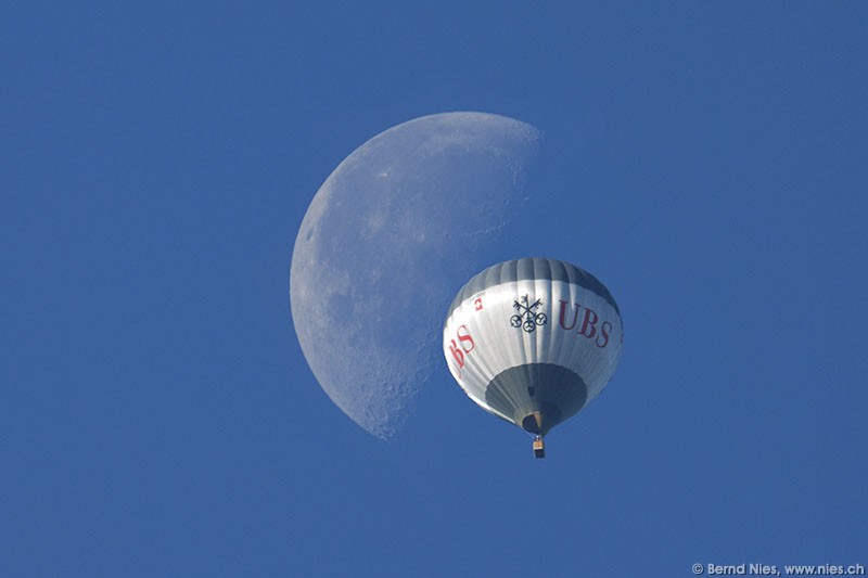 Balloon crossing moon