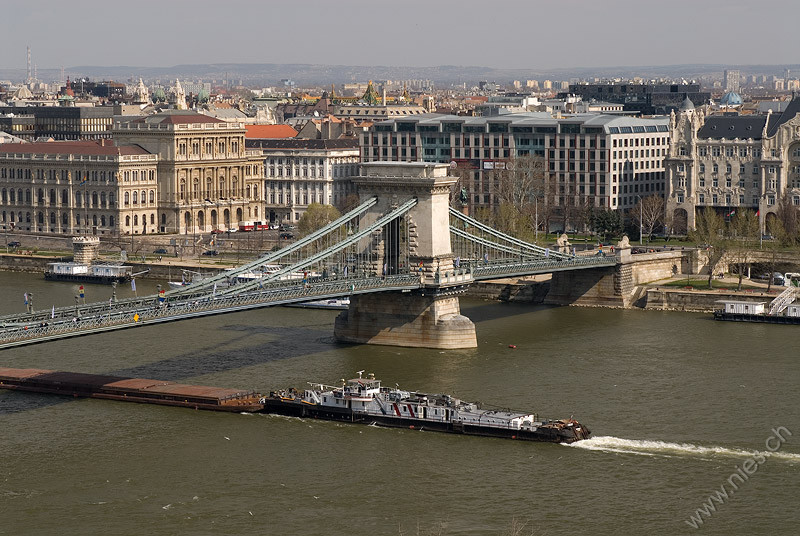 Chain bridge with freight ship