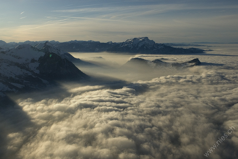 Evening shadows above fog sea