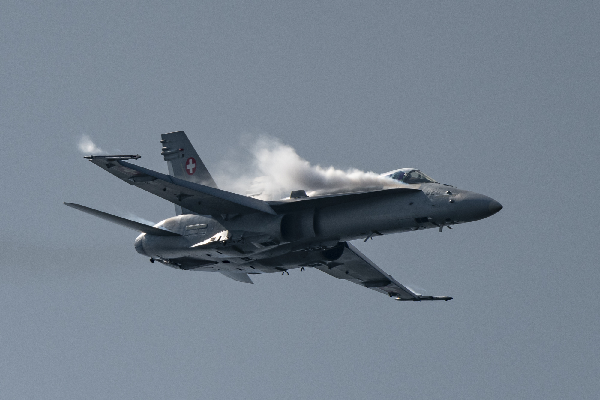 F/A-18 Hornet of Swiss Airforce with lateral chemtrails of Dihydrogenmonoxide