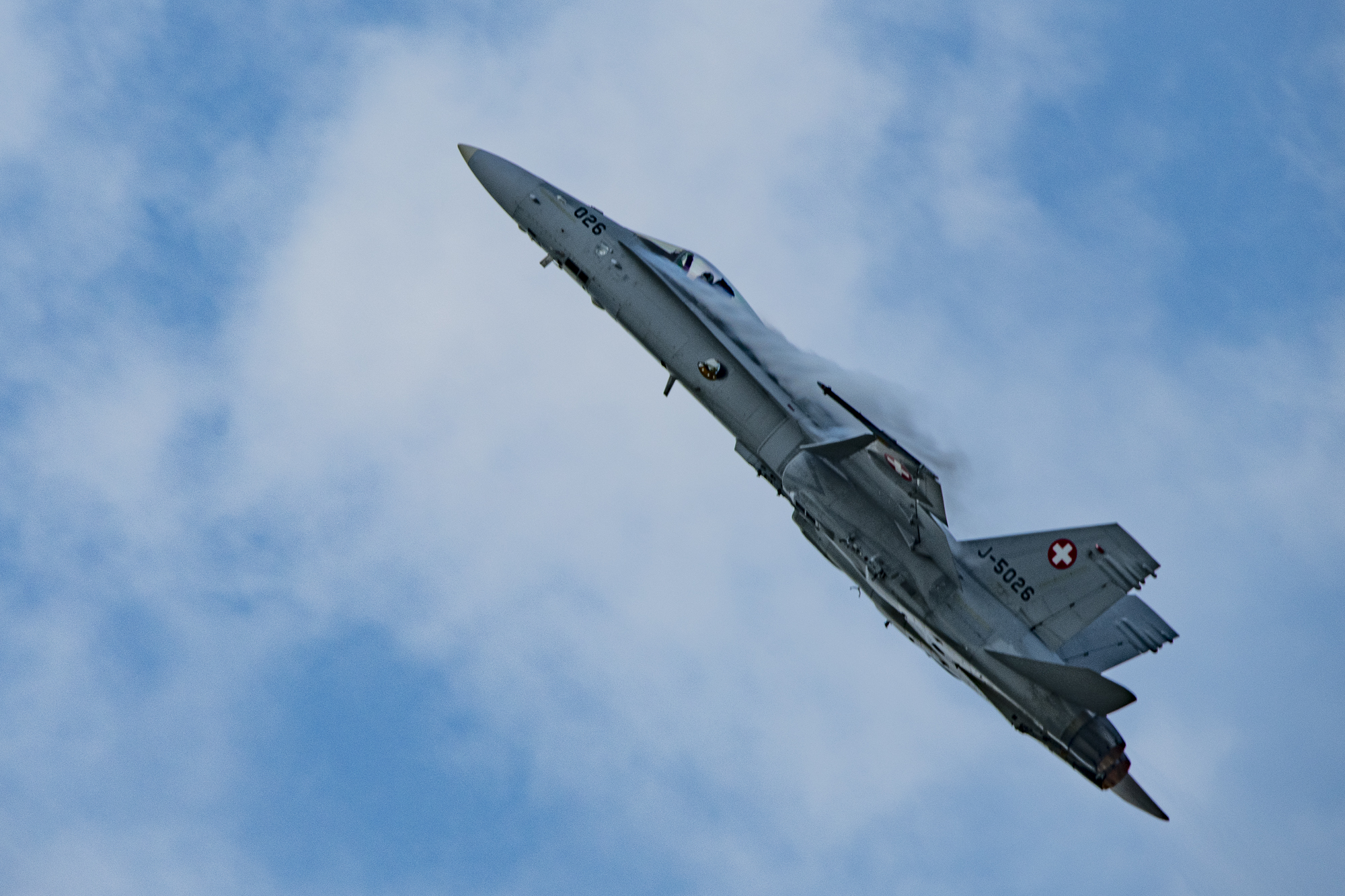 F/A-18 Hornet of Swiss Airforce with lateral chemtrails of Dihydrogenmonoxide