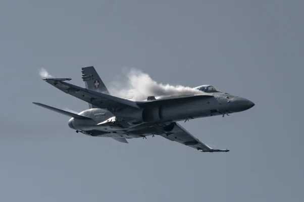 F/A-18 Hornet of Swiss Airforce with lateral chemtrails of Dihydrogenmonoxide