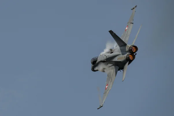 F/A-18 Hornet of Swiss Airforce with lateral chemtrails of Dihydrogenmonoxide